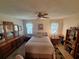 Cozy bedroom featuring a ceiling fan, matching dresser, and ample natural light from the windows at 3835 Sailmaker Ln # X, Holiday, FL 34691
