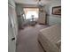 Serene bedroom with a comfortable bed, wicker furniture, and ample closet space, designed for relaxation and storage at 3835 Sailmaker Ln # X, Holiday, FL 34691