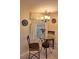 Cozy dining area features a round glass table, decorative lighting, and window with blinds, perfect for intimate meals at 3835 Sailmaker Ln # X, Holiday, FL 34691
