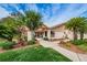 Inviting building with lush landscaping and mature trees at 3835 Sailmaker Ln # X, Holiday, FL 34691