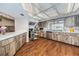Bright kitchen with stainless steel appliances, white countertops, wood-look cabinets and a view of the neighborhood at 3835 Sailmaker Ln # X, Holiday, FL 34691