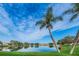 Scenic lake view with palm trees providing a serene backdrop for outdoor enjoyment at 3835 Sailmaker Ln # X, Holiday, FL 34691