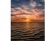 Spectacular sunset over the ocean, painting the sky with vibrant hues of orange, pink, and gold at 3835 Sailmaker Ln # X, Holiday, FL 34691
