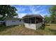 Back exterior featuring a spacious screened-in porch, ideal for relaxing and enjoying the outdoors at 3925 W Eden Roc Cir, Tampa, FL 33634