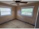 Bedroom with natural light from two windows, awaiting renovation with damaged floor at 3925 W Eden Roc Cir, Tampa, FL 33634
