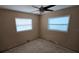 Bedroom with natural light from two windows, awaiting renovation with damaged floor at 3925 W Eden Roc Cir, Tampa, FL 33634