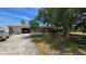 Charming one-story home featuring a brick facade, garage, and mature trees enhancing curb appeal at 3925 W Eden Roc Cir, Tampa, FL 33634