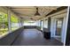 Enclosed porch with lots of natural light, a ceiling fan and doors leading to the yard at 3925 W Eden Roc Cir, Tampa, FL 33634