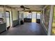 View of screened porch featuring ceiling fan and views of back yard at 3925 W Eden Roc Cir, Tampa, FL 33634