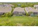 This aerial shows the house with a screened-in pool and lush backyard at 4166 Epic Cv, Land O Lakes, FL 34638