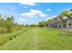 A lush green lawn leads to a screened-in pool at this house at 4166 Epic Cv, Land O Lakes, FL 34638