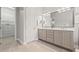 Bathroom boasts double sinks, spacious vanity and a glimpse into a walk-in closet at 4166 Epic Cv, Land O Lakes, FL 34638