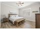 Bedroom with wood-look flooring, bench seat and plantation shutters at 4166 Epic Cv, Land O Lakes, FL 34638
