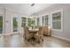 Bright dining area featuring a round table, wicker chairs, and ample natural light through large windows at 4166 Epic Cv, Land O Lakes, FL 34638