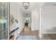 Welcoming entryway with light wood floors, decorative mirror, and stylish console table at 4166 Epic Cv, Land O Lakes, FL 34638