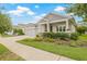 Attractive one-story home featuring a convenient three-car garage and professionally landscaped front yard with vibrant plants at 4166 Epic Cv, Land O Lakes, FL 34638