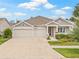 Beautiful one-story home with a convenient three-car garage and manicured front yard, providing great curb appeal at 4166 Epic Cv, Land O Lakes, FL 34638