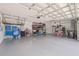 Spacious garage with epoxy flooring, storage shelving, and overhead lighting at 4166 Epic Cv, Land O Lakes, FL 34638