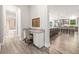 Hallway with built-in desk leads to open-concept kitchen and a full bathroom at 4166 Epic Cv, Land O Lakes, FL 34638