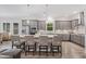 Stylish kitchen featuring gray cabinets, stainless steel appliances, granite counters, and a large island with seating at 4166 Epic Cv, Land O Lakes, FL 34638