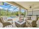 Screened-in lanai with outdoor furniture, fire pit and a view of the pool at 4166 Epic Cv, Land O Lakes, FL 34638