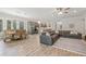 Open floor plan with living room, dining area, and kitchen featuring modern decor and abundant natural light at 4166 Epic Cv, Land O Lakes, FL 34638