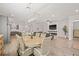 Open-concept living and dining area with modern light fixtures, neutral paint, and wood flooring at 4166 Epic Cv, Land O Lakes, FL 34638