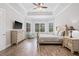 Comfortable main bedroom featuring a tray ceiling, neutral colors, and plantation shutters at 4166 Epic Cv, Land O Lakes, FL 34638