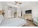 Stylish main bedroom with tray ceilings, TV, and en-suite bath with a walk-in closet at 4166 Epic Cv, Land O Lakes, FL 34638