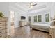 Main bedroom with tray ceiling, neutral color palette, and ensuite bathroom access at 4166 Epic Cv, Land O Lakes, FL 34638