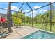 This screened-in lanai features a pool with a view to the backyard at 4166 Epic Cv, Land O Lakes, FL 34638