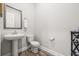 Powder room featuring a pedestal sink, gray trim and stylish fixtures at 4166 Epic Cv, Land O Lakes, FL 34638