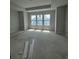 Unfinished bedroom displays a modern tray ceiling and large window, ready for personalization at 479 31St N Way, St Petersburg, FL 33713