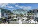 Beautiful townhome courtyard featuring comfortable seating, tables, umbrellas, and palm trees at 479 31St N Way, St Petersburg, FL 33713