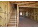 A framed out new construction interior with a view of the unfinished staircase and the spacious unfinished area at 479 31St N Way, St Petersburg, FL 33713