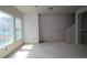 Bright, unfinished living room area shows staircase and a double window for natural light at 479 31St N Way, St Petersburg, FL 33713