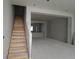 Unfinished living room highlights staircase leading to upper level, spacious layout, and open floor plan at 479 31St N Way, St Petersburg, FL 33713