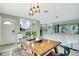 Bright dining area with pendant lighting, open view to the modern kitchen and access to the living room at 5 N Mercury Ave, Clearwater, FL 33765