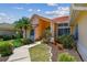 Single-story home featuring a terra cotta roof, tropical landscaping and a tidy walkway leading to the entrance at 5001 Queen Palm Ne Ter, St Petersburg, FL 33701