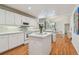 Open-concept kitchen featuring white cabinetry, modern appliances, and hardwood floors at 5001 Queen Palm Ne Ter, St Petersburg, FL 33701