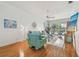 Sunlit living room featuring hardwood floors, cool paint, and comfortable seating at 5001 Queen Palm Ne Ter, St Petersburg, FL 33701