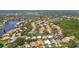 Stunning aerial view of a neighborhood nestled alongside a lake, showcasing lush greenery and varied rooflines at 5001 Queen Palm Ne Ter, St Petersburg, FL 33703
