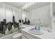 Bright bathroom featuring a tub with shower, city-themed curtain and a white vanity with sink at 5001 Queen Palm Ne Ter, St Petersburg, FL 33703