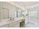 Spacious bathroom with dual sinks, garden tub, shower, and plant decorations for a spa-like feel at 5001 Queen Palm Ne Ter, St Petersburg, FL 33703