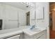 Bathroom with a large mirror, white vanity and a view of the hallway at 5001 Queen Palm Ne Ter, St Petersburg, FL 33703
