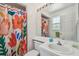 Bathroom with a white vanity, large mirror, and shower with a colorful curtain at 5001 Queen Palm Ne Ter, St Petersburg, FL 33703