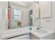 Bright bathroom featuring a large mirror, white vanity and a window at 5001 Queen Palm Ne Ter, St Petersburg, FL 33703