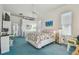 Comfortable bedroom with blue carpet, ceiling fan, and a view of an adjacent bathroom at 5001 Queen Palm Ne Ter, St Petersburg, FL 33703