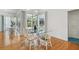 Dining area with glass table and chairs, adjacent to screened-in pool area at 5001 Queen Palm Ne Ter, St Petersburg, FL 33703