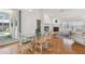 Bright dining area with a glass table, wood floors, and views of the backyard pool at 5001 Queen Palm Ne Ter, St Petersburg, FL 33703